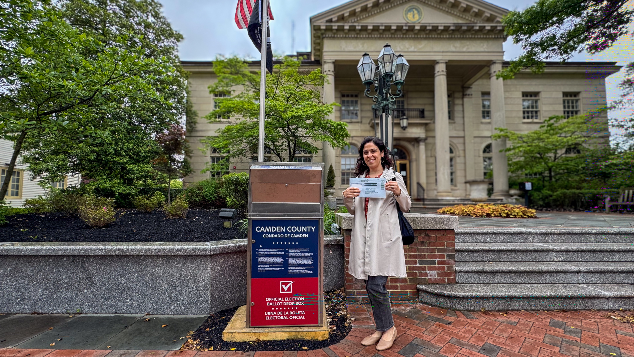 Itir Cole standing next to the Vote By Mail Drop Box in front of Haddonfield Borough Hall